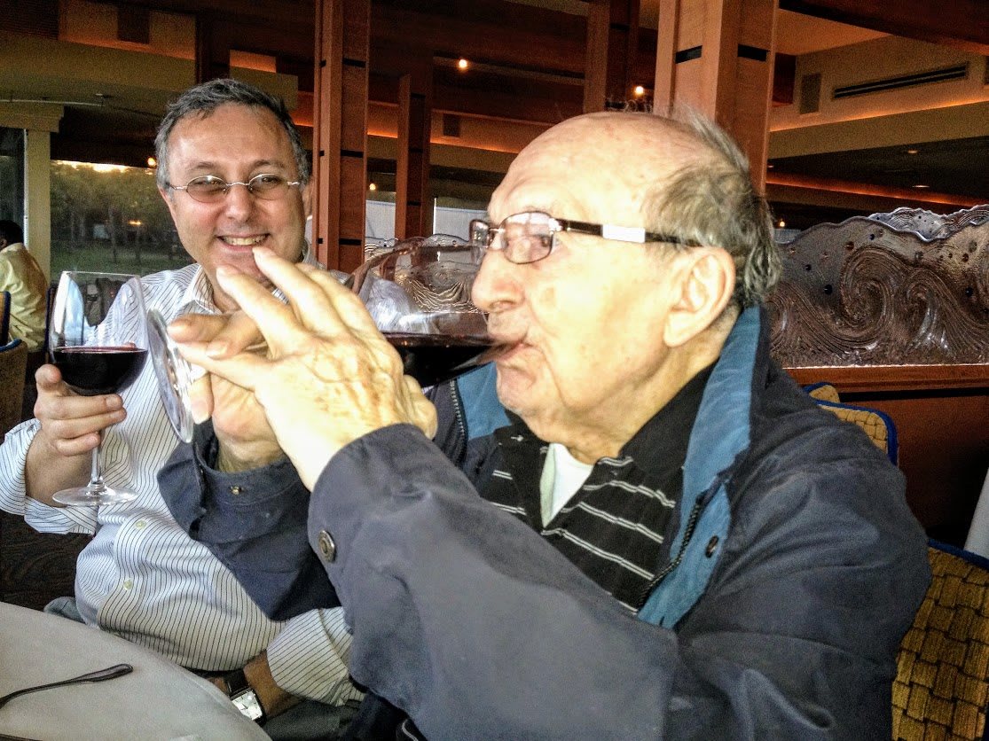 Two people enjoying wine at a restaurant.