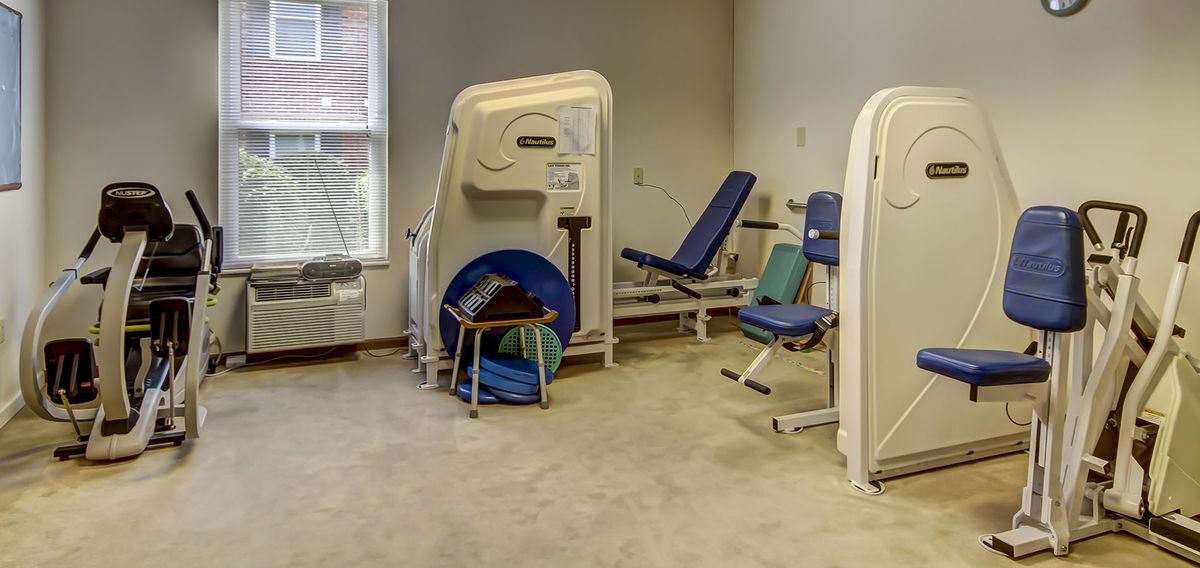 A small gym room with exercise machines and fitness equipment.