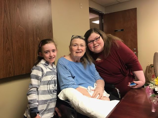 A joyful moment shared among three generations of a family.