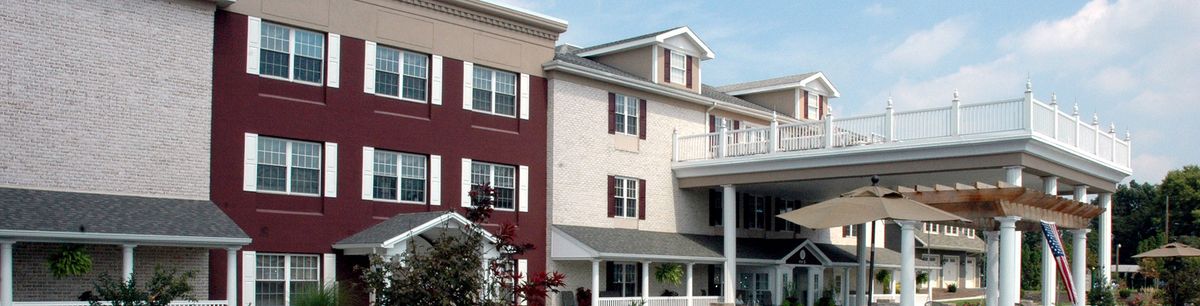A multi-story residential building with red and beige exterior walls.