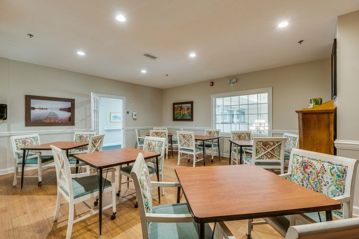 A well-lit dining area with wooden tables and chairs, featuring a warm and inviting atmosphere.