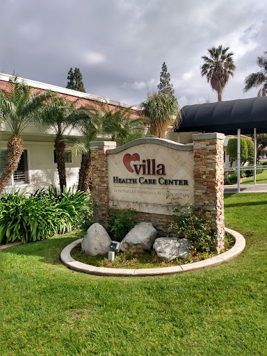 Entrance to Villa Health Care Center with landscaped surroundings.