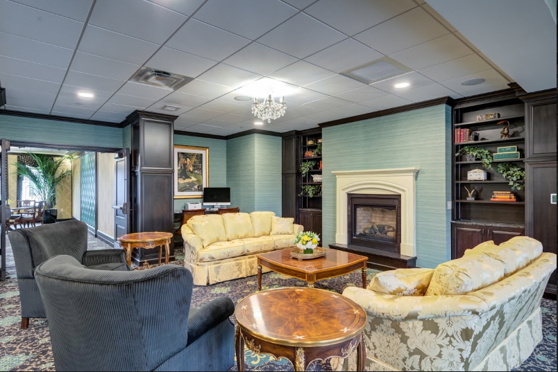 A cozy living room featuring a fireplace, sofas, and elegant decor.