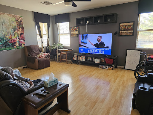 A cozy living room with a large TV and comfortable seating.