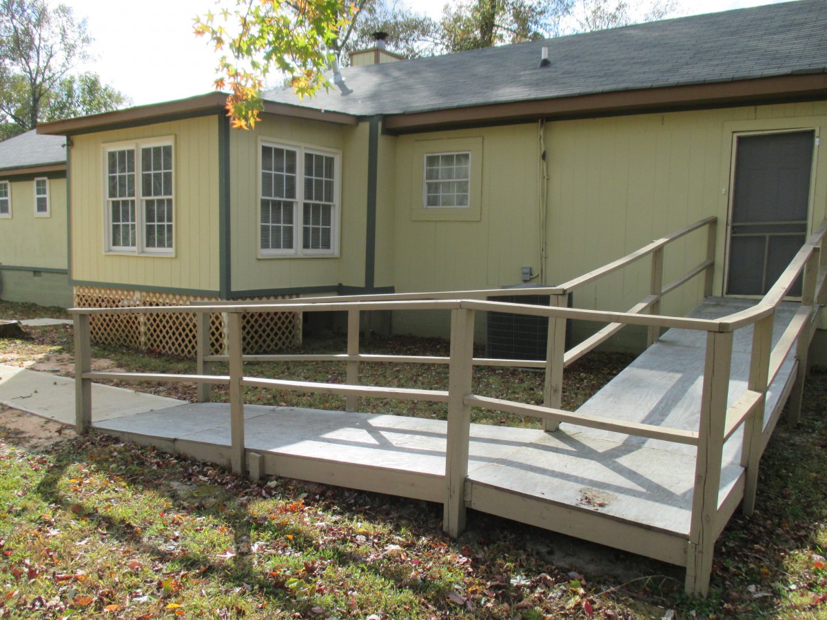 A house exterior with an accessible ramp leading to the entrance.