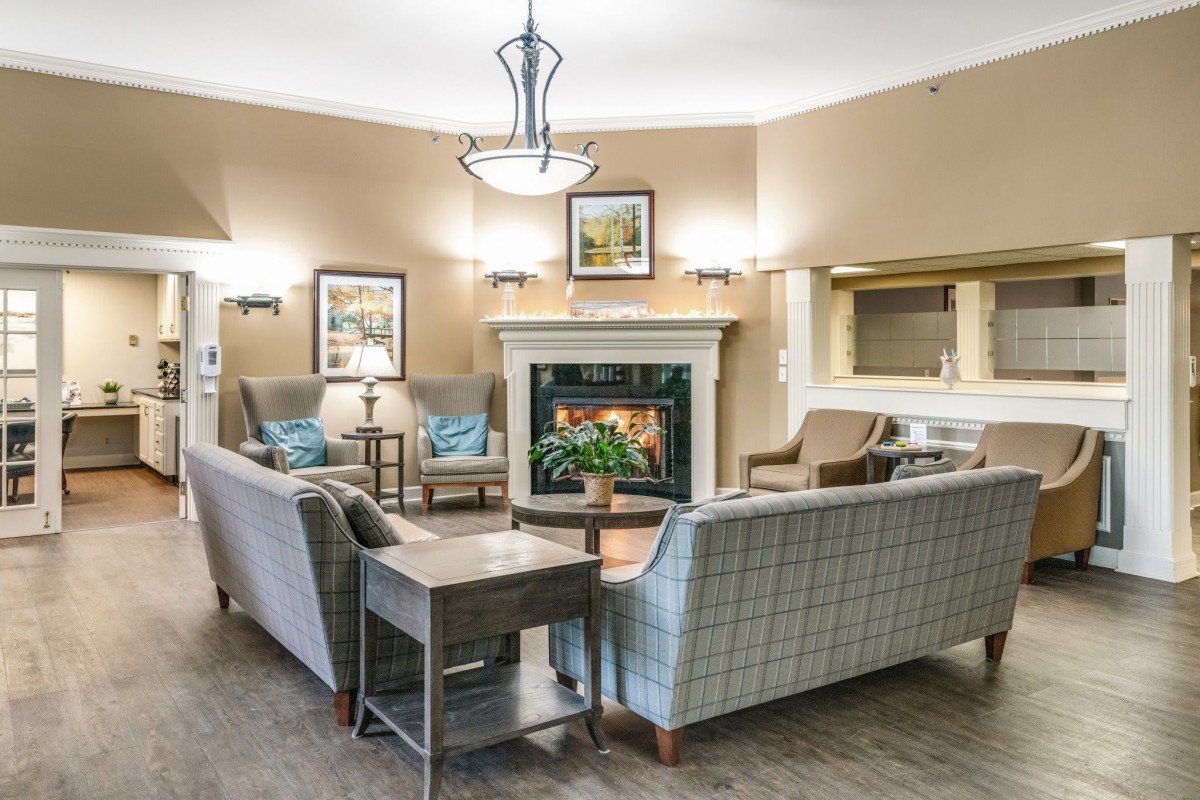 A cozy living room with a fireplace, comfortable seating, and elegant interior design.