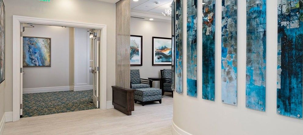 A modern waiting area featuring stylish furniture and contemporary artwork on the walls.