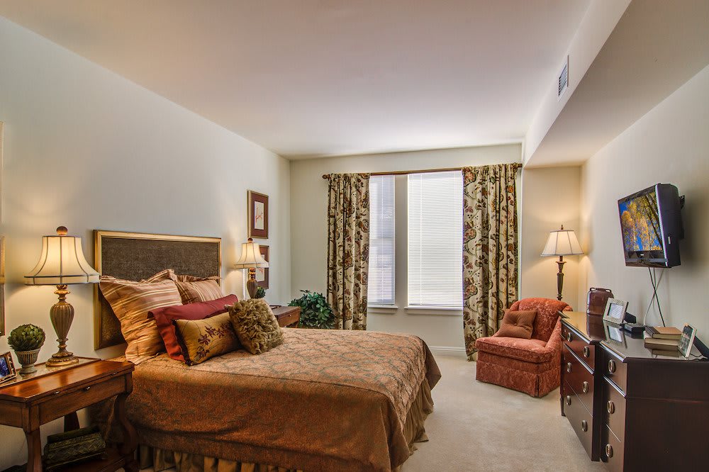 A cozy bedroom with warm decor and comfortable furnishings.