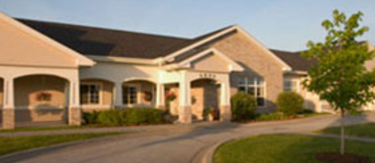 A suburban residential house with a landscaped driveway.