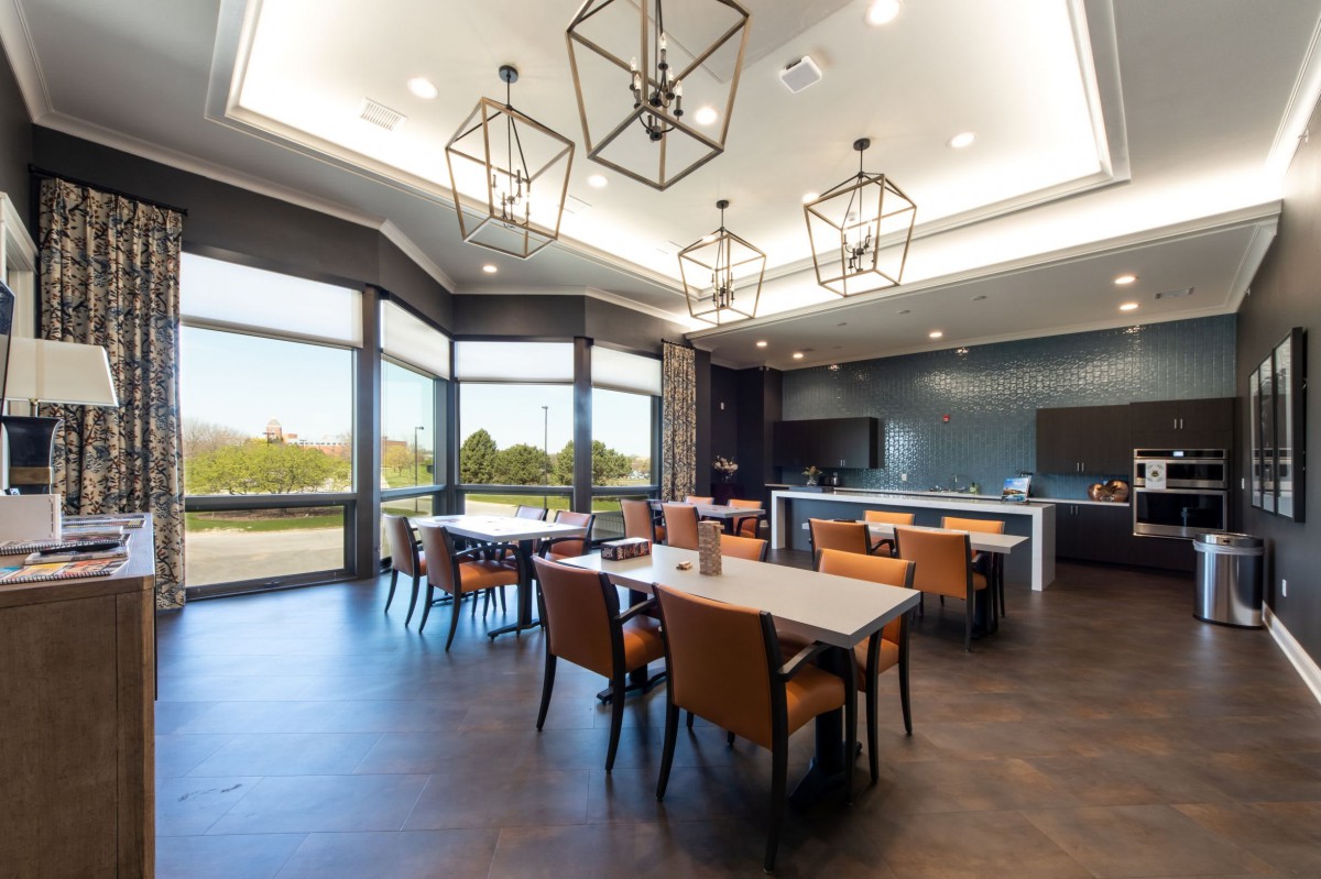 A modern dining area with large windows and elegant lighting fixtures.