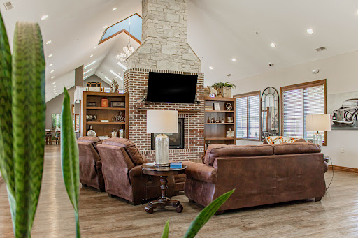 A beautifully designed living room featuring a modern fireplace, cozy seating, and ample natural light.