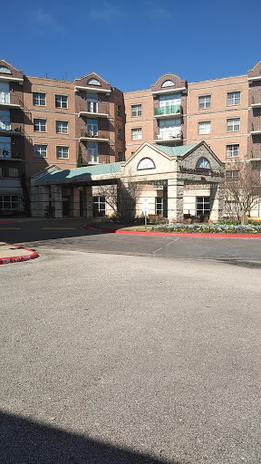 The entrance to a residential apartment building, featuring classical architectural elements.