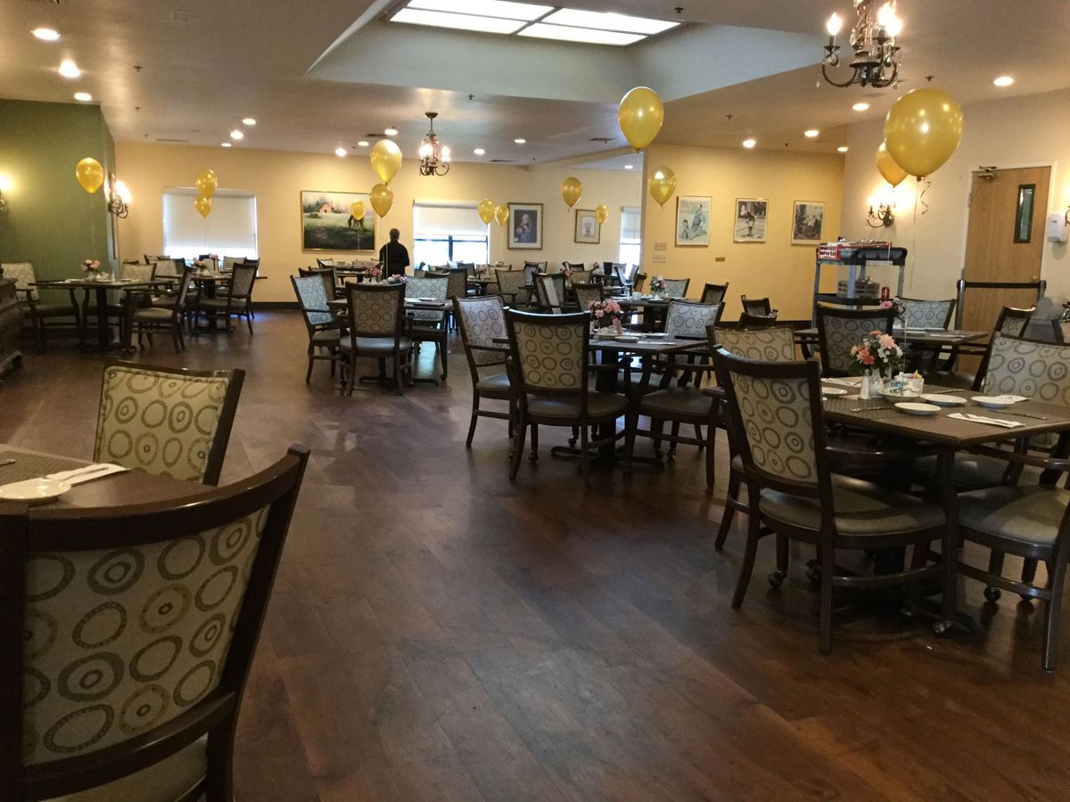 A spacious dining area with elegant furniture and festive decorations.