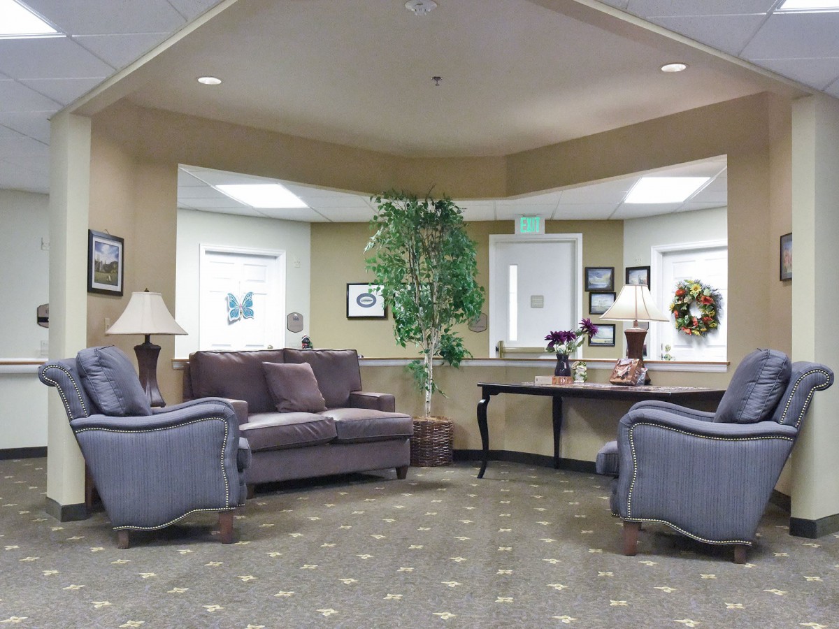 A cozy waiting room with comfortable sofas and tasteful decor.