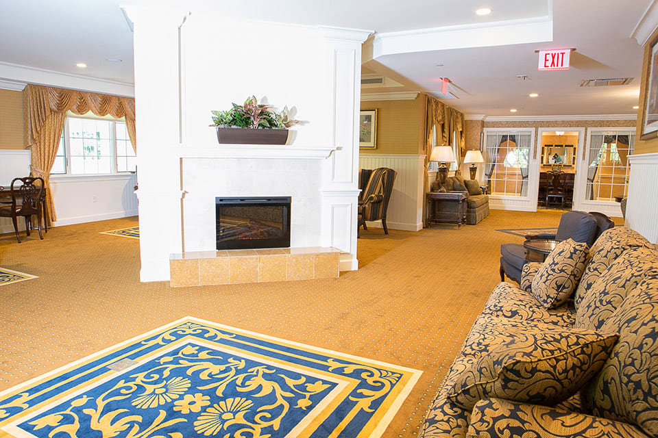 A cozy hotel lobby with a fireplace and comfortable seating.