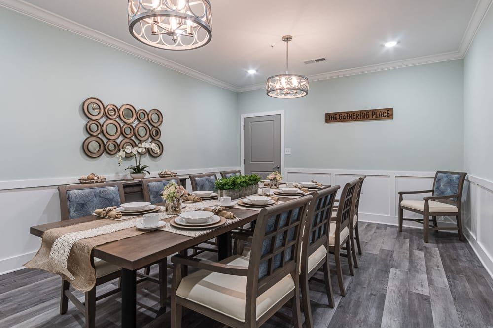 Elegant dining room with modern decor and chandeliers.