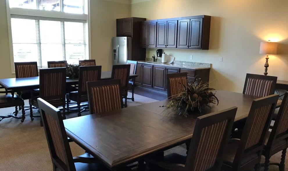 A spacious kitchen and dining area with wooden furniture and modern appliances.