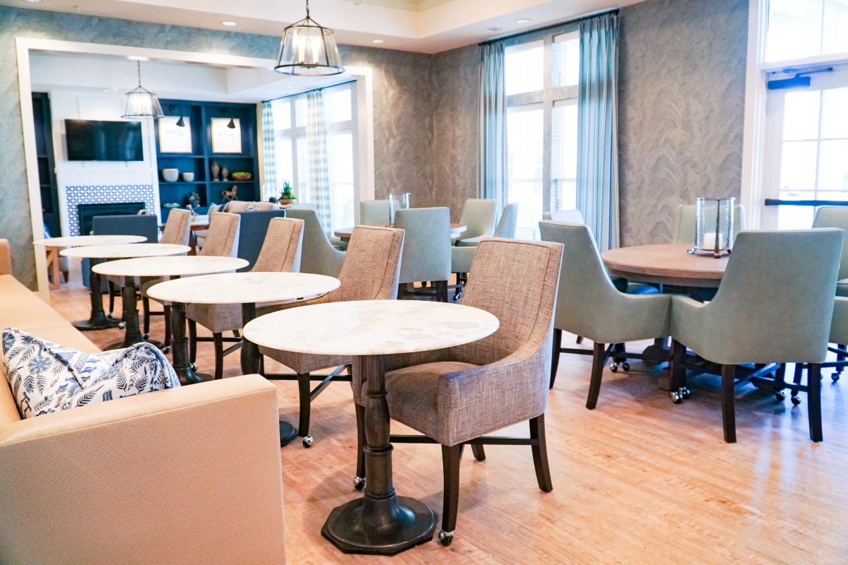 A modern dining area with neatly arranged tables and chairs, featuring a stylish interior design.