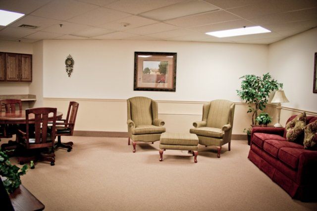 A waiting area with chairs, a table, and decorative elements.