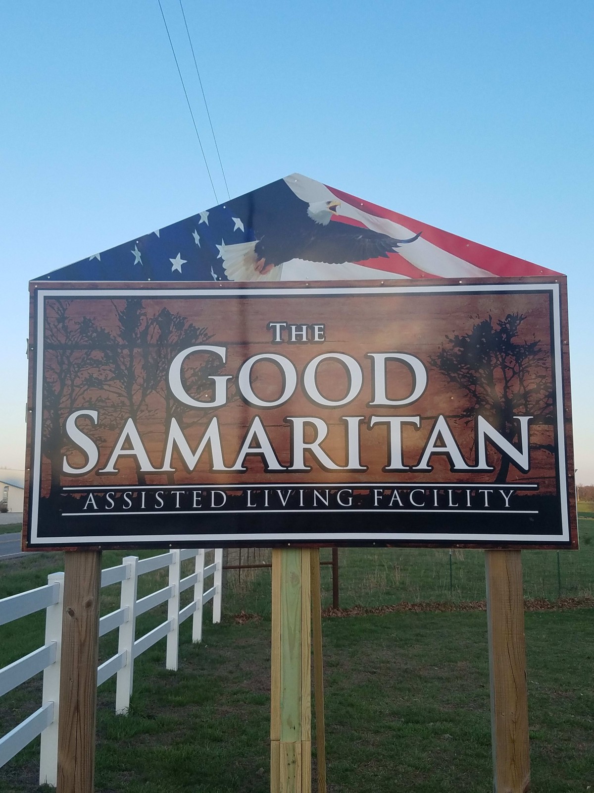 Sign for The Good Samaritan Assisted Living Facility with an American flag design.