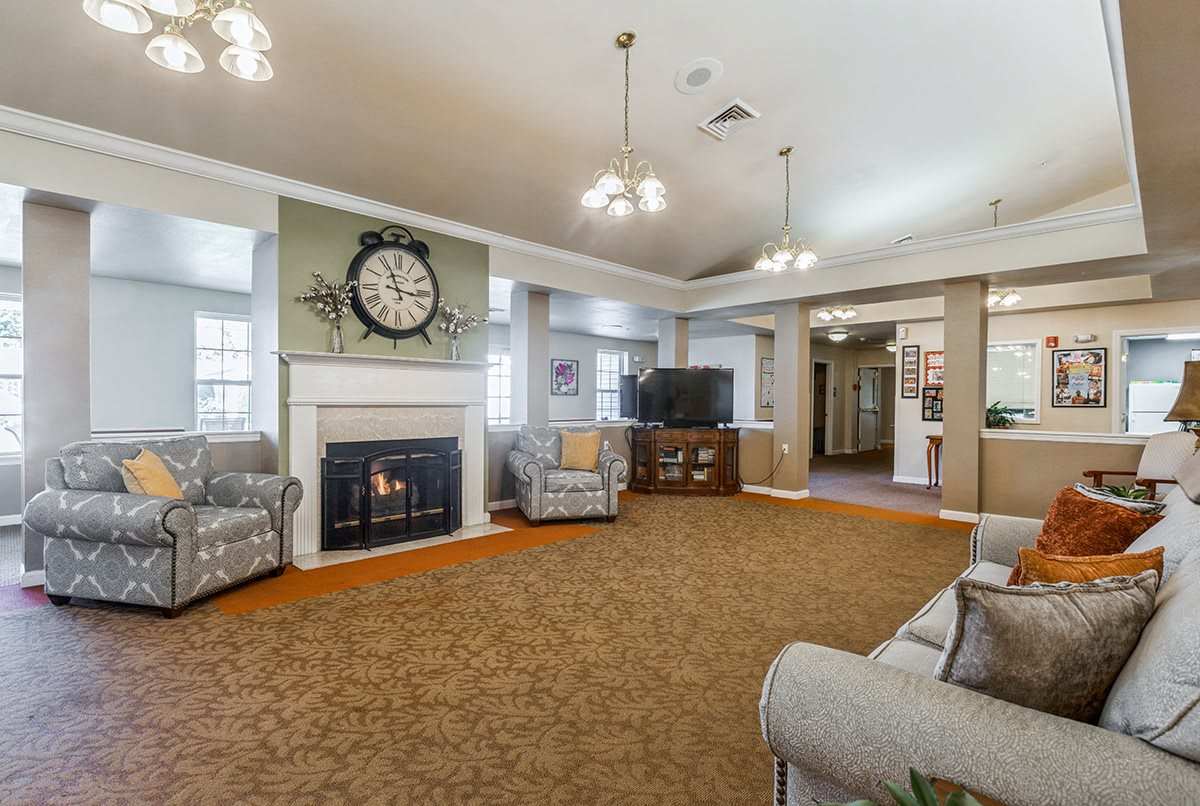 A spacious living room with a fireplace and classic decor.