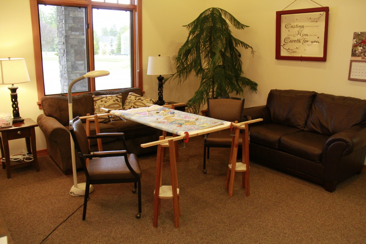 A cozy living room setup with a sofa, chairs, and a table supported by adjustable stands.