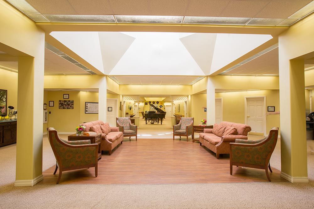 A spacious lobby area featuring comfortable seating and a grand piano.