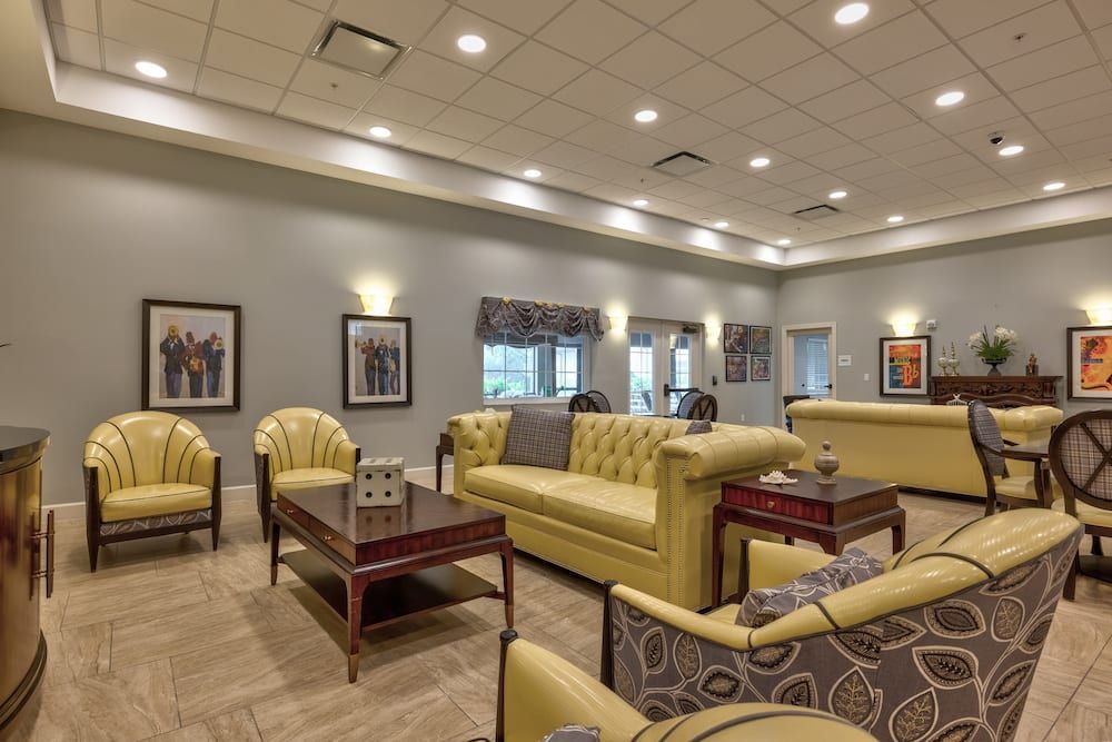 A modern lounge area with yellow sofas and armchairs, complemented by coffee tables and ambient lighting.