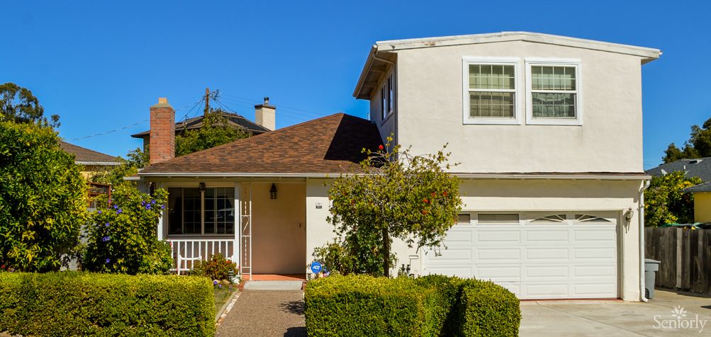 A suburban two-story house with well-maintained landscaping.