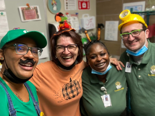 A joyful moment shared among colleagues, celebrating together in fun costumes.