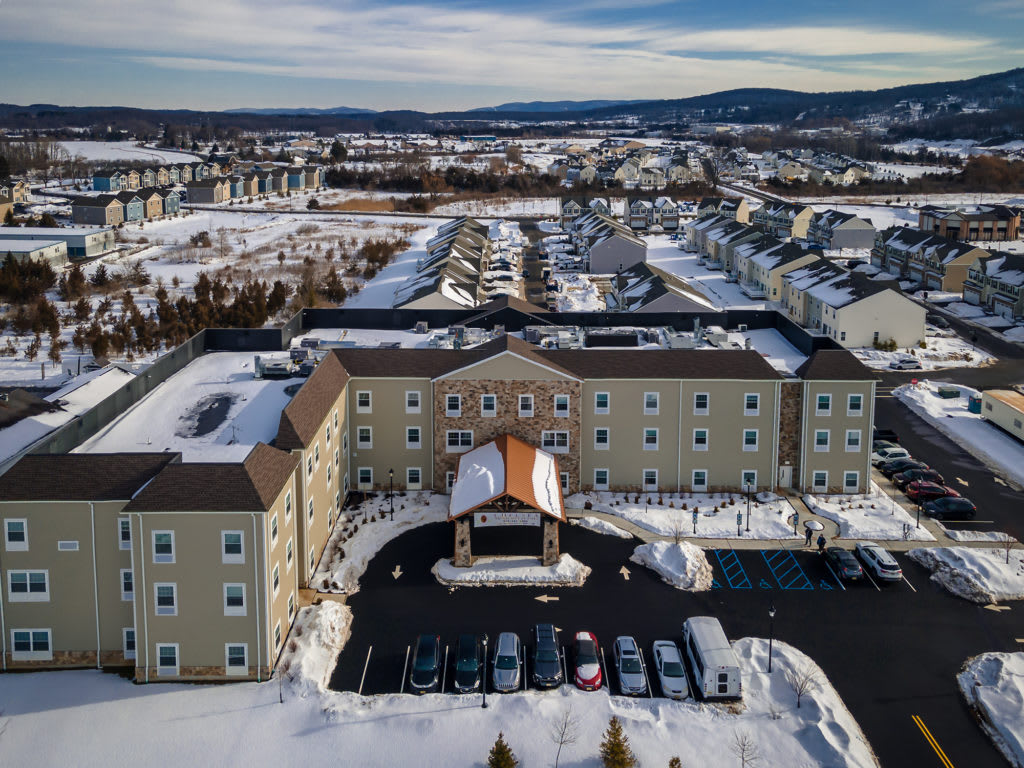 Aerial view of a hotel surrounded by a snowy residential area.