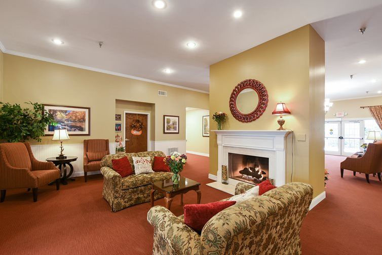 A cozy living room with traditional decor featuring a warm fireplace and comfortable seating.