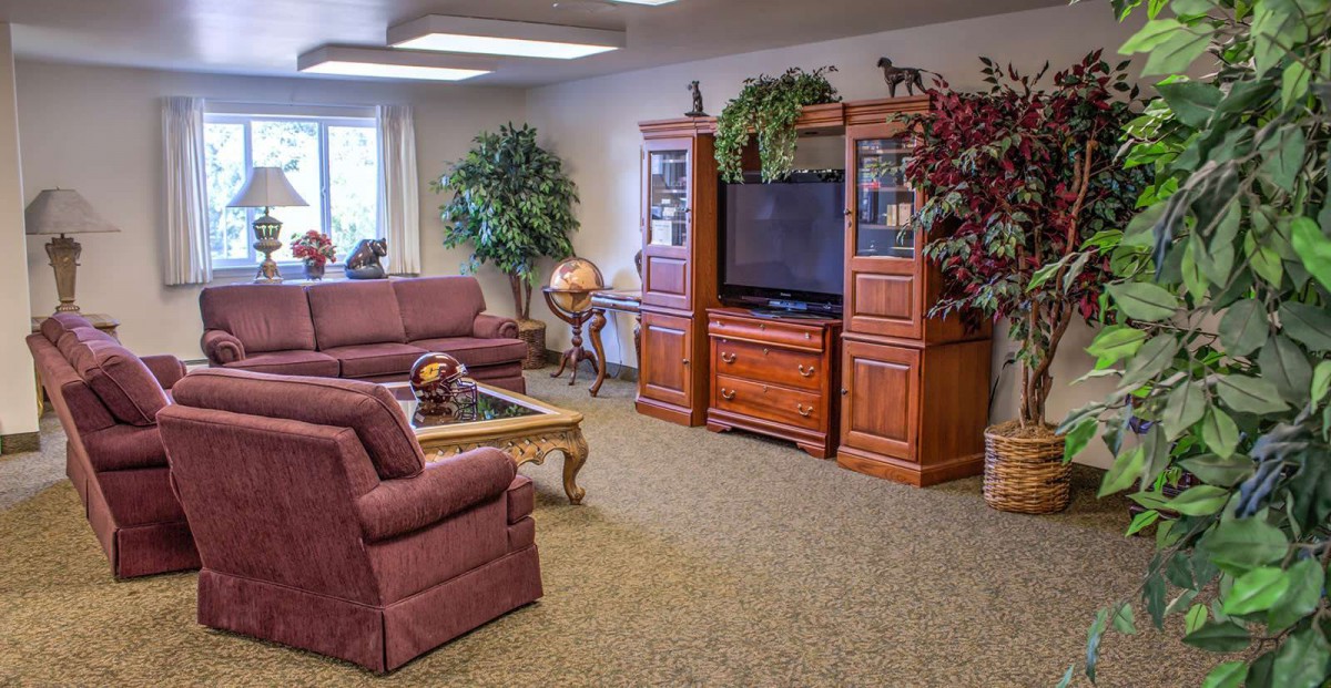 A cozy living room with comfortable seating and a large entertainment center.