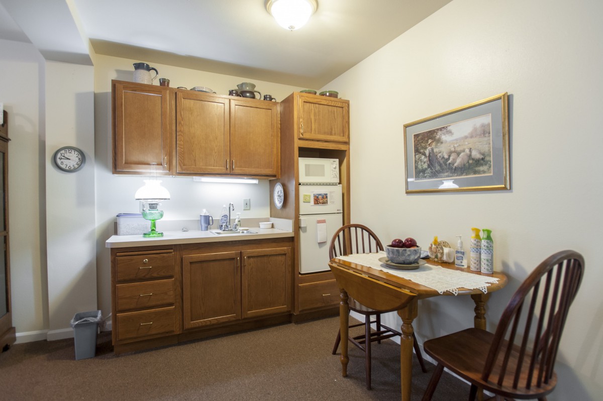 A cozy kitchen area with wooden cabinets and a small dining table.
