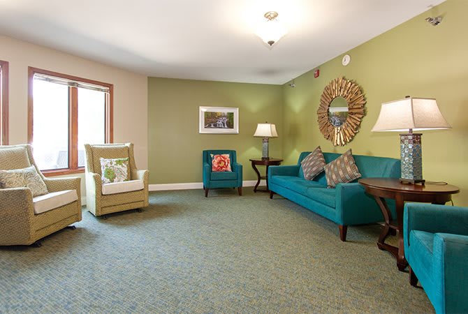 A cozy living room with colorful furniture and decorative elements.