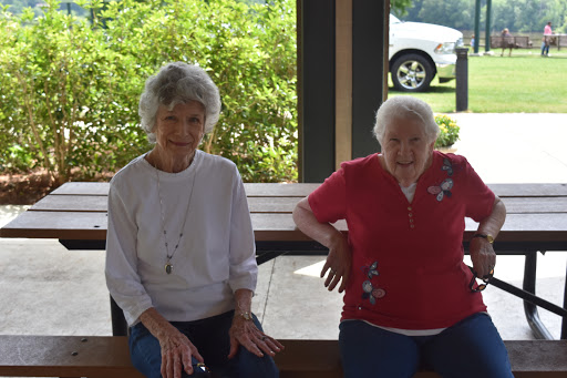 Two elderly women enjoying a sunny day together.
