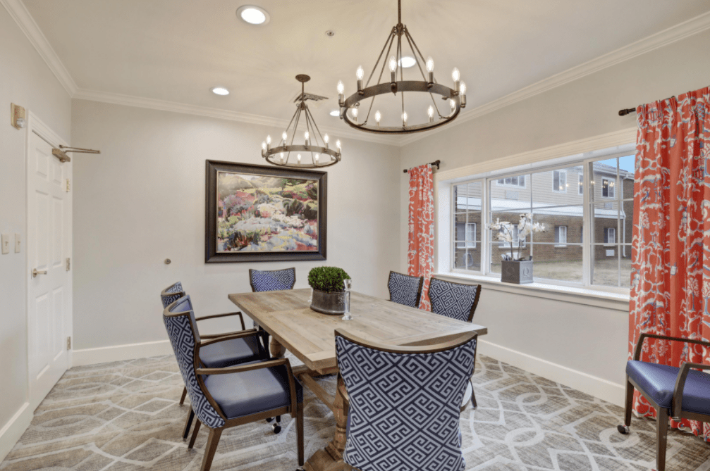 A stylish dining room with elegant chandeliers and modern decor.
