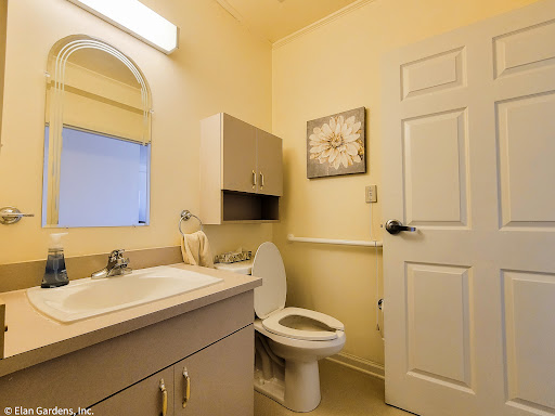 A well-lit and organized bathroom featuring a modern sink, toilet, and ample storage space.