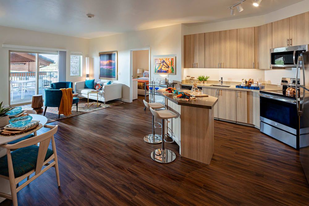 A modern open-concept kitchen and living room with contemporary furniture.