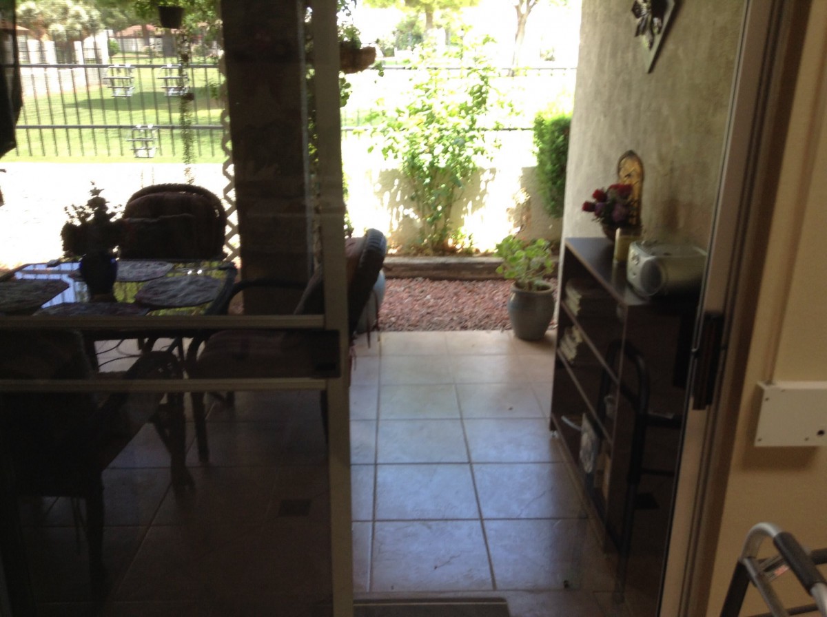 A cozy patio area with furniture and a garden view.