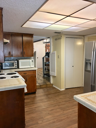A spacious kitchen featuring wooden cabinets and modern appliances.