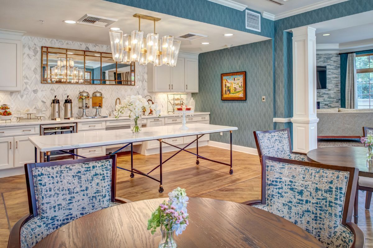 A modern kitchen and dining area with elegant lighting and contemporary furniture.