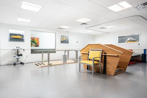 A modern interior space featuring minimalist furniture and artwork, possibly designed for therapeutic or medical purposes.
