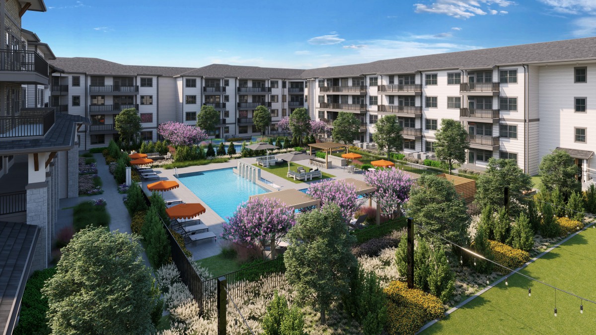 A modern residential complex featuring a central swimming pool surrounded by lush landscaping and outdoor seating.