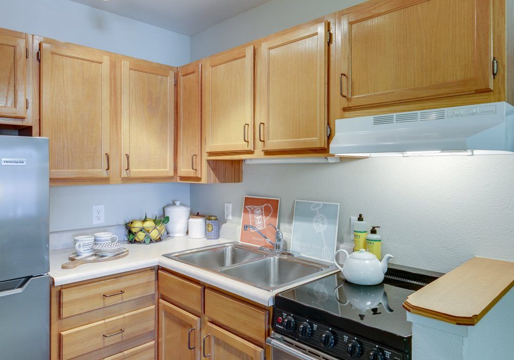 A small kitchen with wooden cabinets and a compact cooking area.