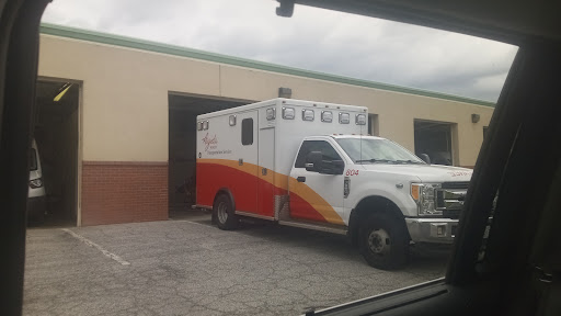 An ambulance parked outside a service building.