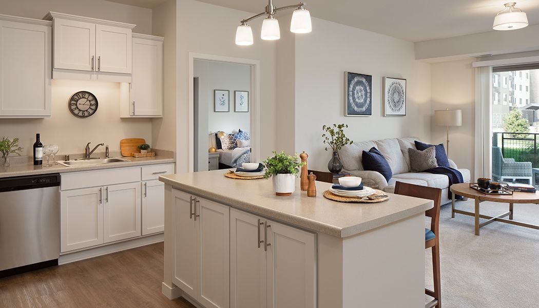 Modern open-concept kitchen and living area with stylish decor and a central island.
