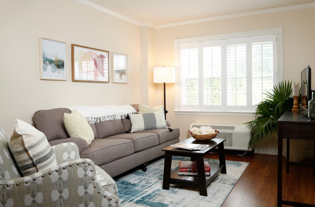 A cozy living room with a comfortable sofa, coffee table, and warm lighting.