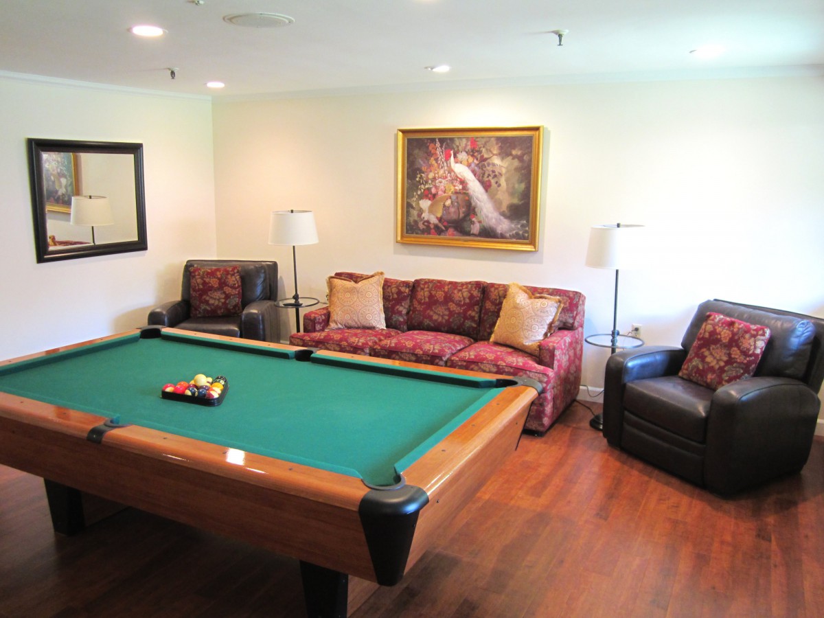 A cozy living room with a pool table and stylish furniture.