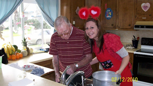 A cheerful moment in the kitchen with a loved one, sharing laughter and cooking.